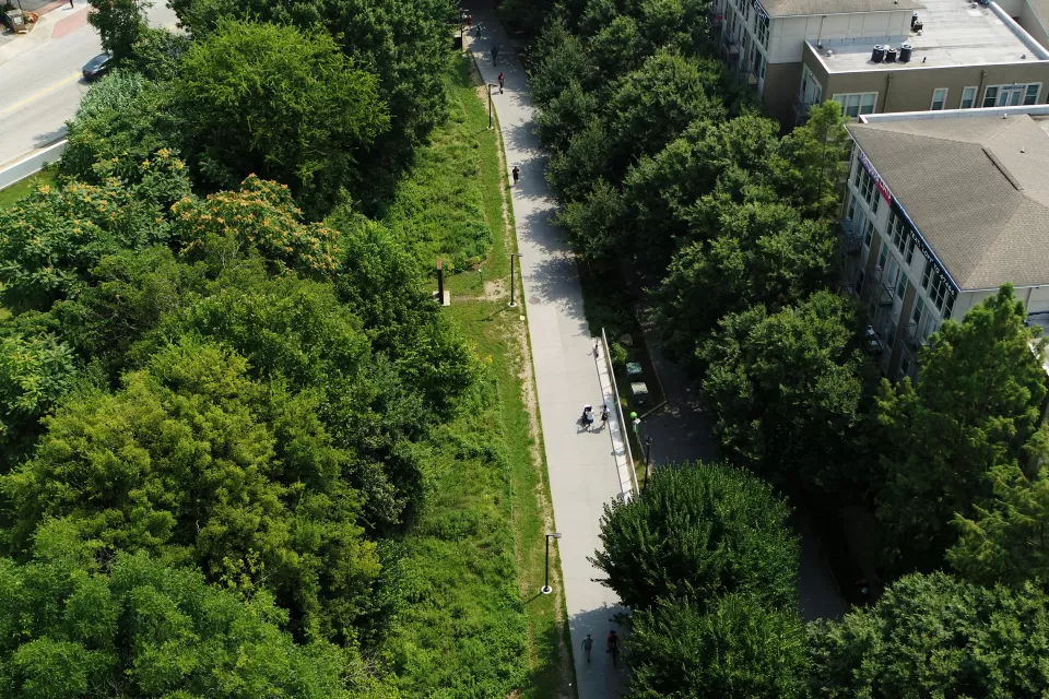 Aerial view of Atlanta BeltLine paved bike trail surrounded by green trees